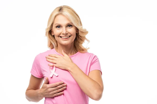 Blonde woman looking at camera while touching breast isolated on white, breast cancer concept — Stock Photo