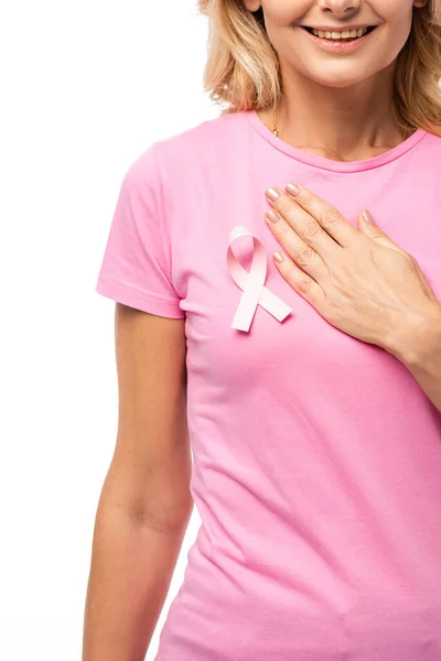 Cropped view of woman in t-shirt with ribbon of breast cancer awareness and hand on chest isolated on white — Stock Photo