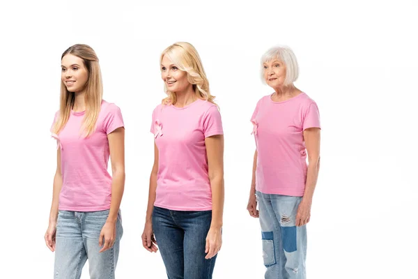 Women with breast cancer awareness ribbons looking away isolated on white — Stock Photo