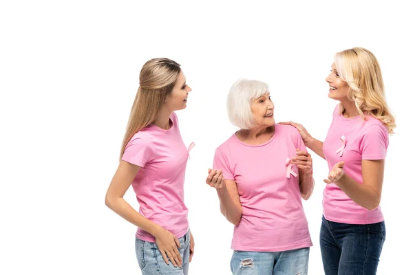 Women with pink ribbons of breast cancer awareness talking isolated on white — Stock Photo