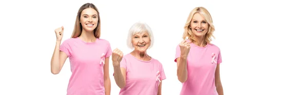 Panoramic shot of women in t-shirts with ribbons of breast cancer awareness showing yeah isolated on white — Stock Photo