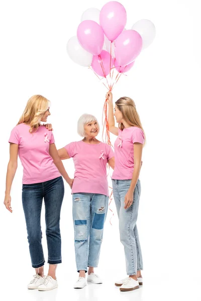 Mulheres com balões ad fitas de consciência do câncer de mama abraçando em fundo branco — Fotografia de Stock