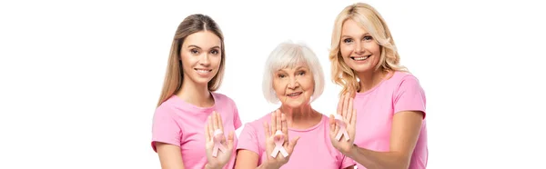 Website header of women looking at camera while showing pink ribbons isolated on white — Stock Photo