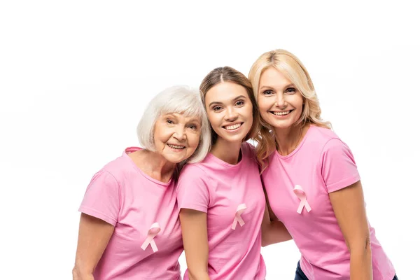 Mulheres com fitas rosa em camisetas olhando para câmera isolada em branco — Fotografia de Stock