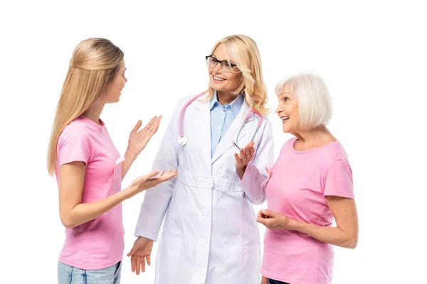 Young woman with pink ribbon on t-shirt pointing with hands near doctor isolated on white — Stock Photo