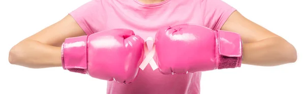 Panoramic shot of young woman in pink boxing gloves holding ribbon of breast cancer awareness isolated on white — Stock Photo
