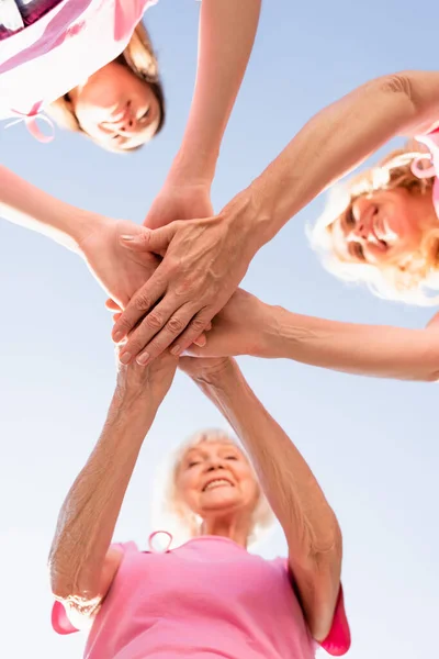 Bottom view of women's stacking hands, concept of breast cancer — Stock Photo