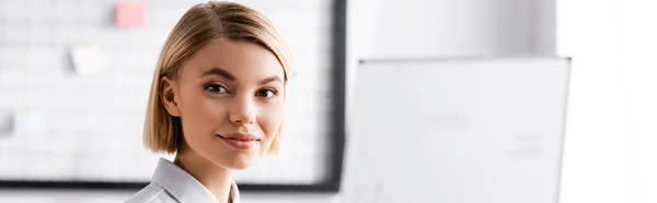 Cheerful young businesswoman smiling at camera, banner — Stock Photo