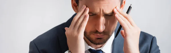 Tired businessman with migraine, holding hands near temples on white background, banner — Stock Photo