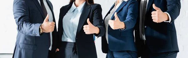 Cropped view of women and men in formal wear showing thumbs up while standing together, banner — Stock Photo