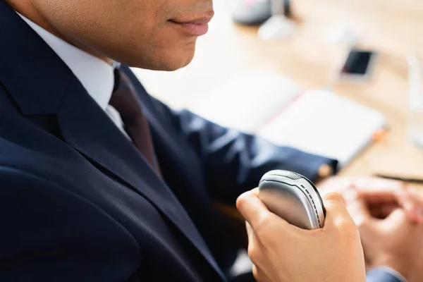 Vue recadrée d'un journaliste avec dictaphone interviewant un politicien indien lors d'une conférence de presse sur fond flou — Photo de stock