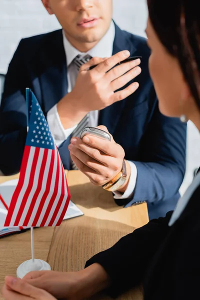 Partial view of journalist with dictaphone and pen interviewing politician during press conference, blurred foreground — Stock Photo