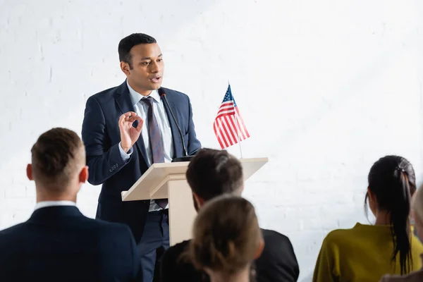 Serious indian agitator talking to voters in conference room — Stock Photo