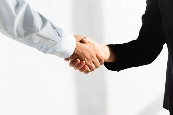 Partial view of politicians shaking hands on white — Stock Photo