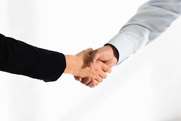 Cropped view of politicians shaking hands on white — Stock Photo