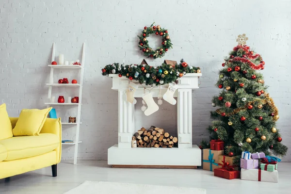 Arbre de Noël, couronne, bas et cheminée dans le salon décoré — Photo de stock