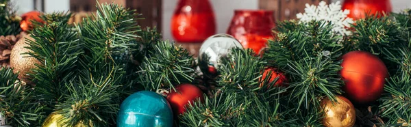 Colorful christmas balls on green pine, banner — Stock Photo