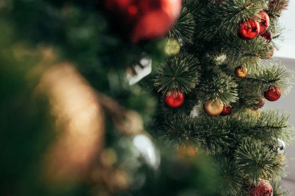 Colorful christmas balls on green pine — Stock Photo