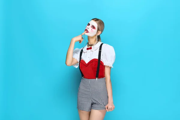 Young woman enjoys Halloween festivities in a stylish costume with vibrant colors and spooky flair. — Stock Photo