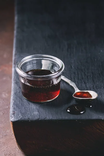Homemade Liquid Transparent Brown Sugar Caramel Glass Jar Standing Black — Stock Photo, Image