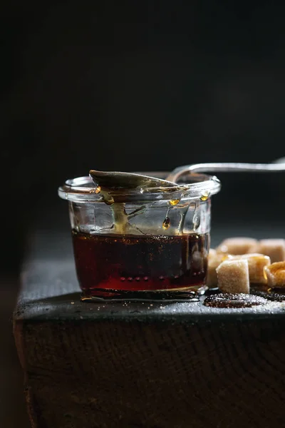 Homemade Liquid Transparent Brown Sugar Caramel Glass Jar Standing Black — Stock Photo, Image