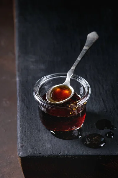 Homemade Liquid Transparent Brown Sugar Caramel Glass Jar Standing Black — Stock Photo, Image