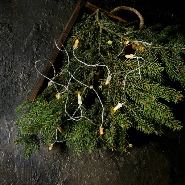 Boże Narodzenie Światła Garland Jodły Zielone Gałęzie Drzewa Drewniana Taca — Zdjęcie stockowe