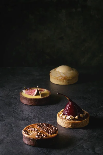 Mängd Söta Tartlets Med Choklad Karamell Päron Fikon Svart Textur — Stockfoto