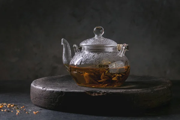热绿茶在透明玻璃茶壶站立在黏土托盘在黑色大理石桌 — 图库照片