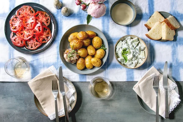 Dinner table with baked potatoes — Stock Photo, Image