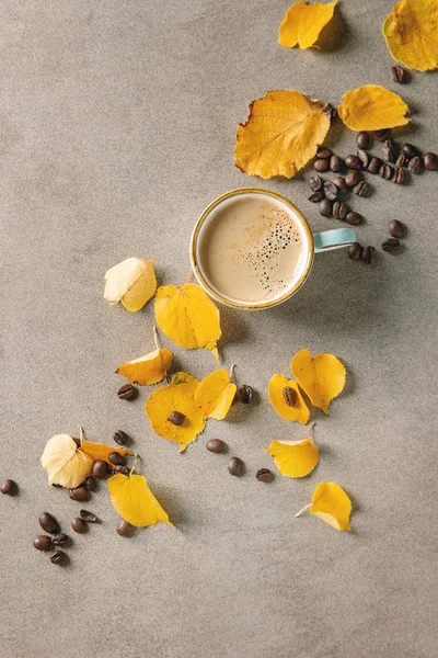 Autumn coffee with yellow leaves