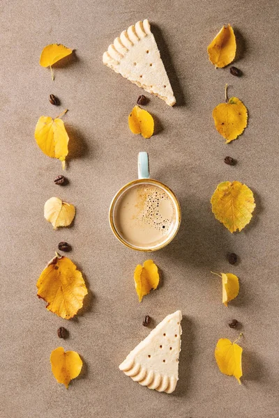 Autumn coffee with yellow leaves