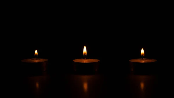 Три Освітлені Воскові Свічки Чорному Тлі — стокове фото