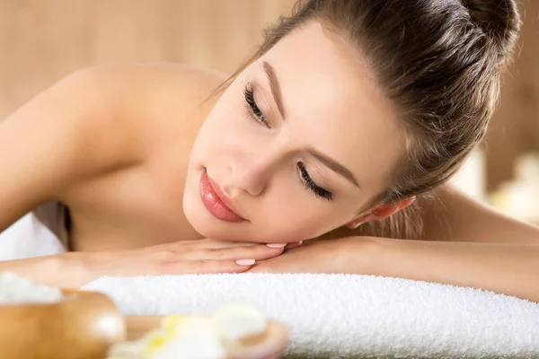 Beautiful young woman laying at spa salon — Stock Photo, Image