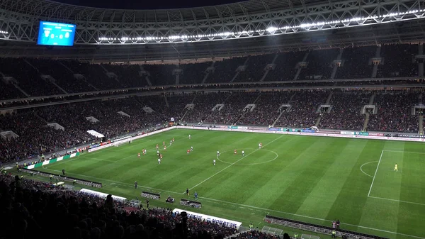 Campo de futebol. As pessoas assistem futebol nas bancadas . — Fotografia de Stock