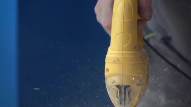 Slow motion shot of a carpenter sawing a wooden Board. Working with an automatic electric saw works in a carpentry workshop. The concept of handmade. — Stock Video