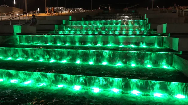 Fountain at night. Water light show on the stairs.