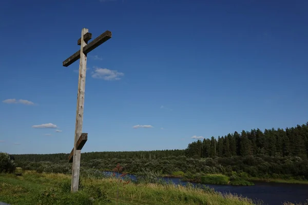 Orthodox cross on the river Bank