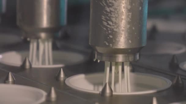 Fabricação de creme azedo. De máquina industrial derramando creme azedo em latas vazias na fábrica moderna — Vídeo de Stock