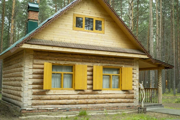 Wooden log house. Window with shutters of a wooden house