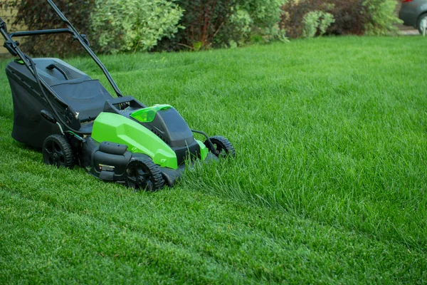 Lawn mower on a green lawn. — Stock Photo, Image