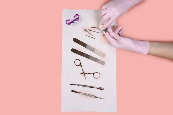 sterilization and disinfection. Manicure tool in the hands of the master. Wiping on a dry manicure tool after soaking in a chemical solution.