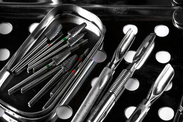 Professional manicure tools. Closeup Of Nail Care Tools. set of metallic manicure tools macro sterilization, disinfection.