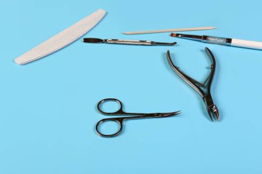 Mavi arka planda manikür aksesuarları seti. Kopya uzayı ile düz konum. Metin için yeri olan kart için kompozisyon.