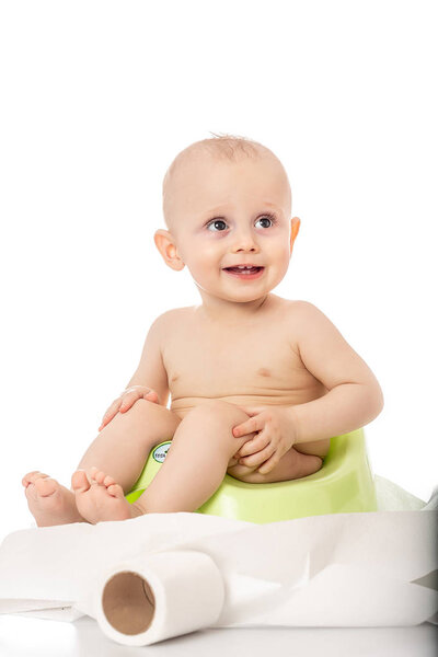 baby smiling and sitting on the potty on white background. banner for text or design.