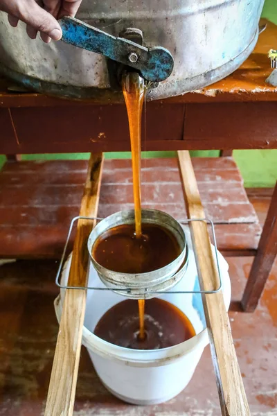 close-up Beekeeper uncapping. strain the honey through the sieve from the honeypot. close-up Beekeeper uncapping. Beekeeping concept