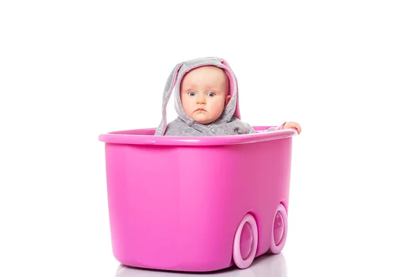 Adorable baby sitting in pink box, close up. children's games — Stock Photo, Image