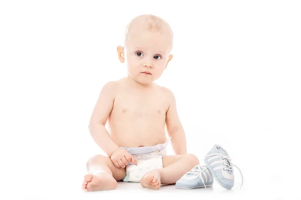 Happy child is sitting on floor, isolated over white. space for text. — Stock Photo, Image