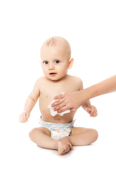 Hygiene - young momy wiping the baby skin with wet wipes isolated on a white background — Stock Photo, Image