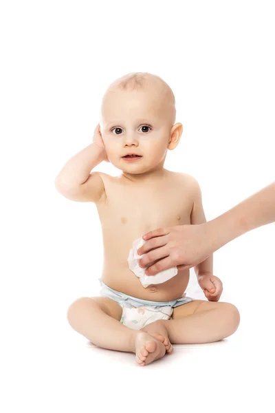 Hygiene - junge Mama wischt die Babyhaut mit Feuchttüchern isoliert auf weißem Hintergrund ab — Stockfoto